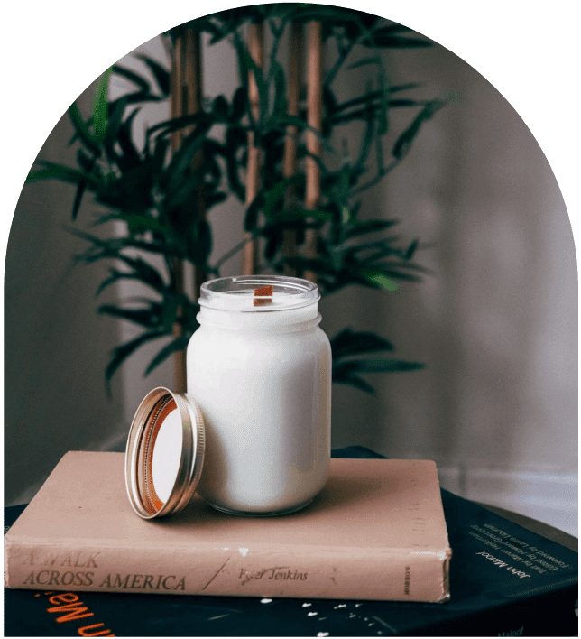 A jar of milk sitting on top of a book.