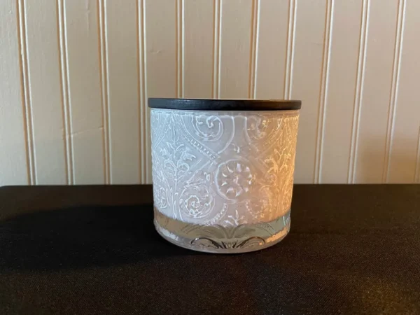 A candle holder with a white and black design.